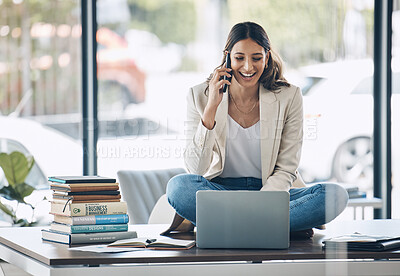 Buy stock photo Worker, laptop and phone call laughing while sitting on desk in relax startup, marketing company or business. Happy smile, talking and woman on mobile communication technology, laptop or books study
