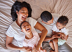 Top view, love and black family in bedroom, playful and cheerful on weekend break, quality time or happiness. African American mother, father or children on bed, joyful or relax with support or laugh