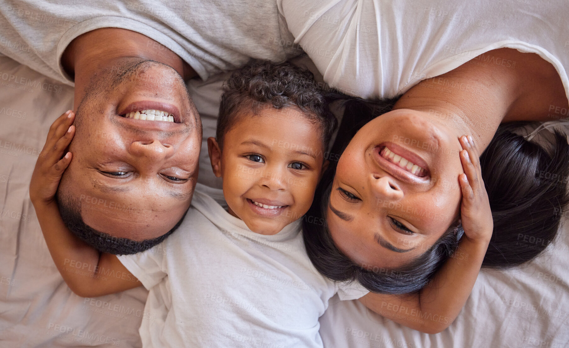 Buy stock photo Above, portrait and happy family relax in bed, children and bonding in their home together. Love, face and boy with parents waking up in a bedroom, smile and resting on the weekend, cosy and content 