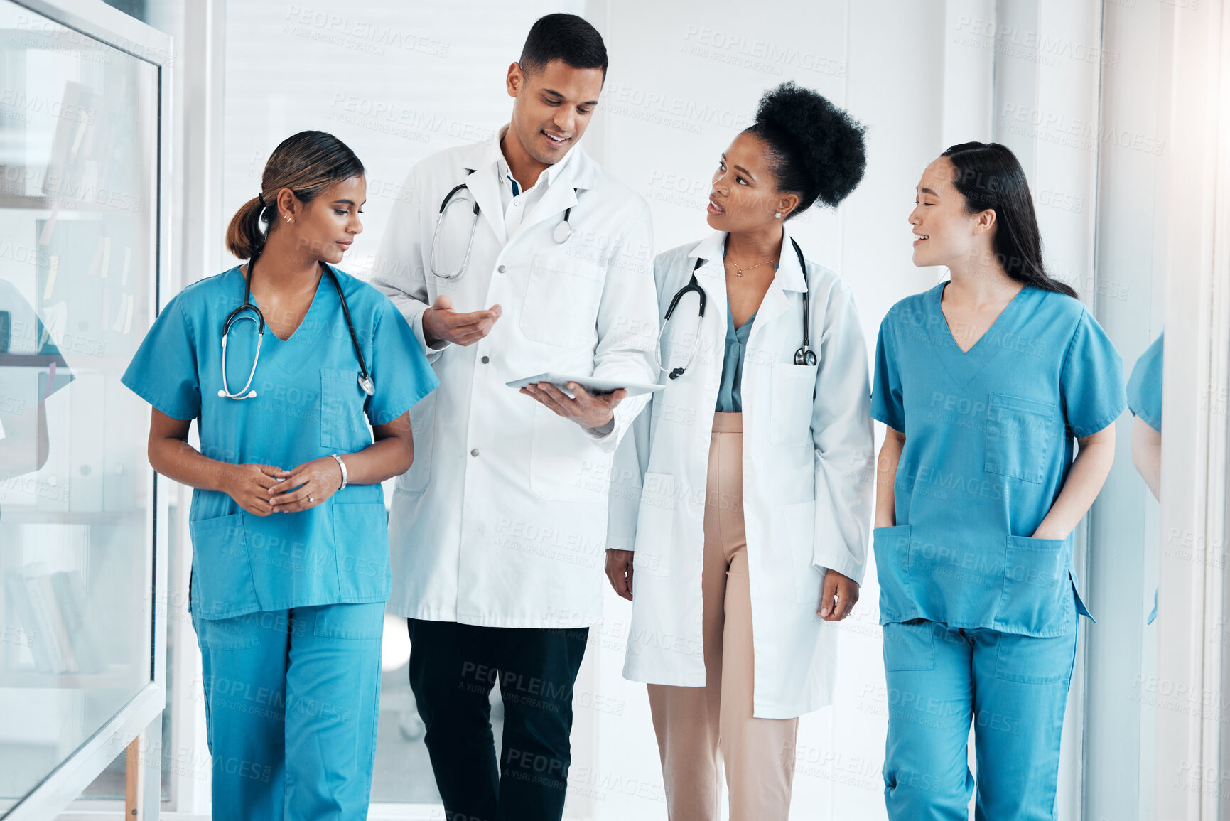 Buy stock photo Doctor walkings, hospital tablet and healthcare talking and consulting with data. Teamwork, nurse collaboration and doctors in a wellness and health clinic with nurses discussion and diversity