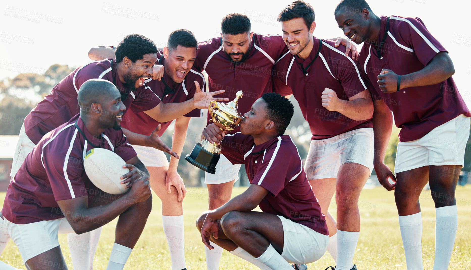 Buy stock photo Sports, winner and rugby team with trophy from winning competition, match and sport game. Success, training and happy, excited and players cheer celebrate victory, achievement and kiss award on field