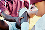 Knee pain, sport injury and bandage on athlete outdoor, rugby and fitness with black man, team and first aid. Medical emergency, wound and sports accident, training and exercise with help and medic