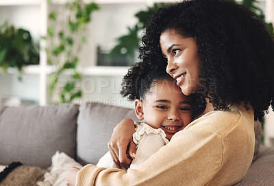 Buy stock photo Hug, love and black family by girl and mother on a sofa, happy and relax in their home together. Mom, daughter and embrace on a couch, cheerful and content while sharing a sweet moment of bonding