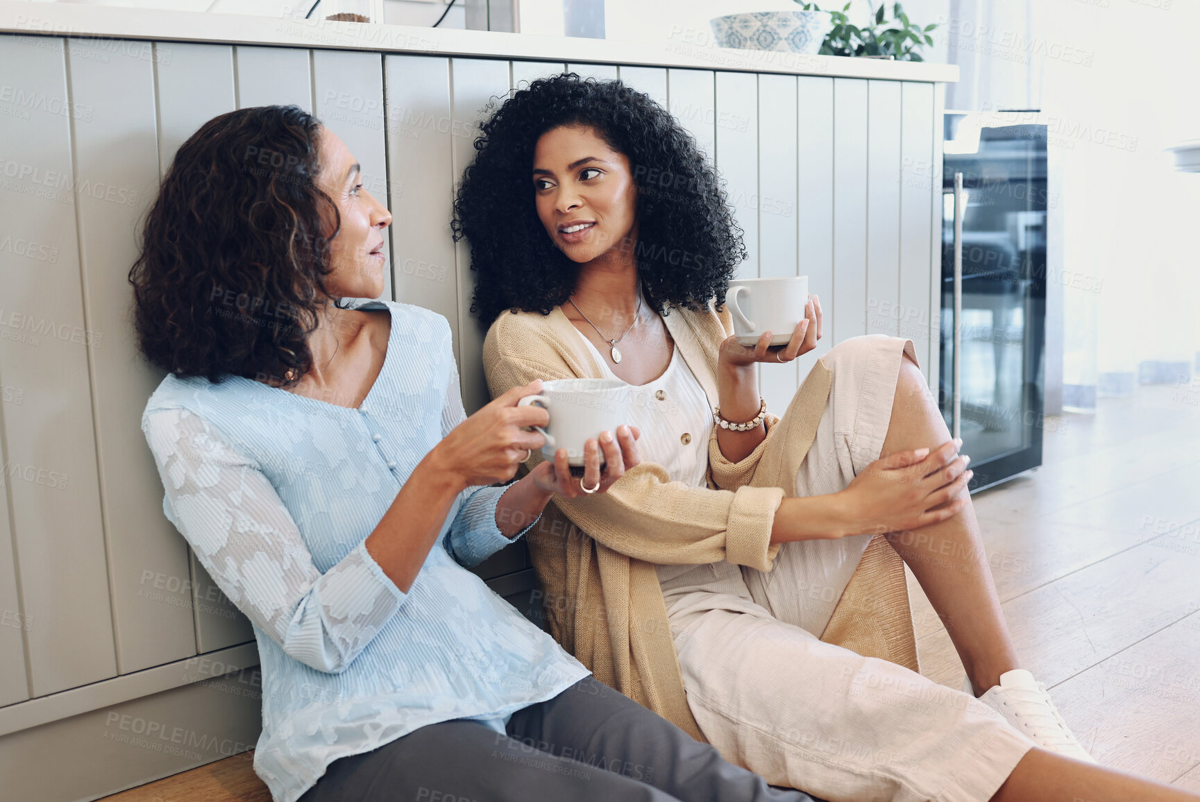 Buy stock photo Coffee, mother and adult daughter on floor, love and conversation for quality time, loving and bonding. Family with gossip, mama or female drinking tea, ground or discussion on break, relax or advice