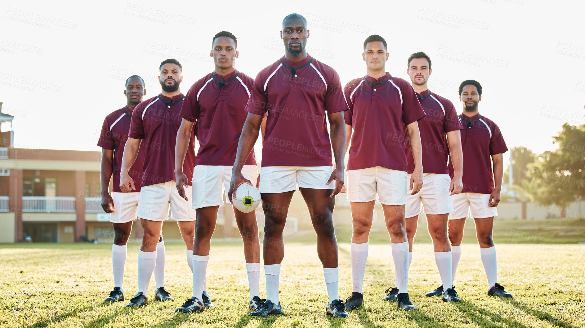Buy stock photo Rugby, black man and strong team portrait on field, solidarity and confidence for winning game. Diversity, leadership and teamwork, group of strong sports people standing together in power on grass.