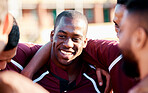 Sports, huddle and man athlete on a field for motivation or strategy planning with his team. Fitness, workout and happy African male rugby player talking with his sport group before a match or game.
