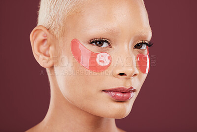 Buy stock photo Portrait, eye mask and beauty with a model black woman posing in studio on a red background for skincare. Face, skin and antiaging with an attractive young female posing to promote a cosmetic product