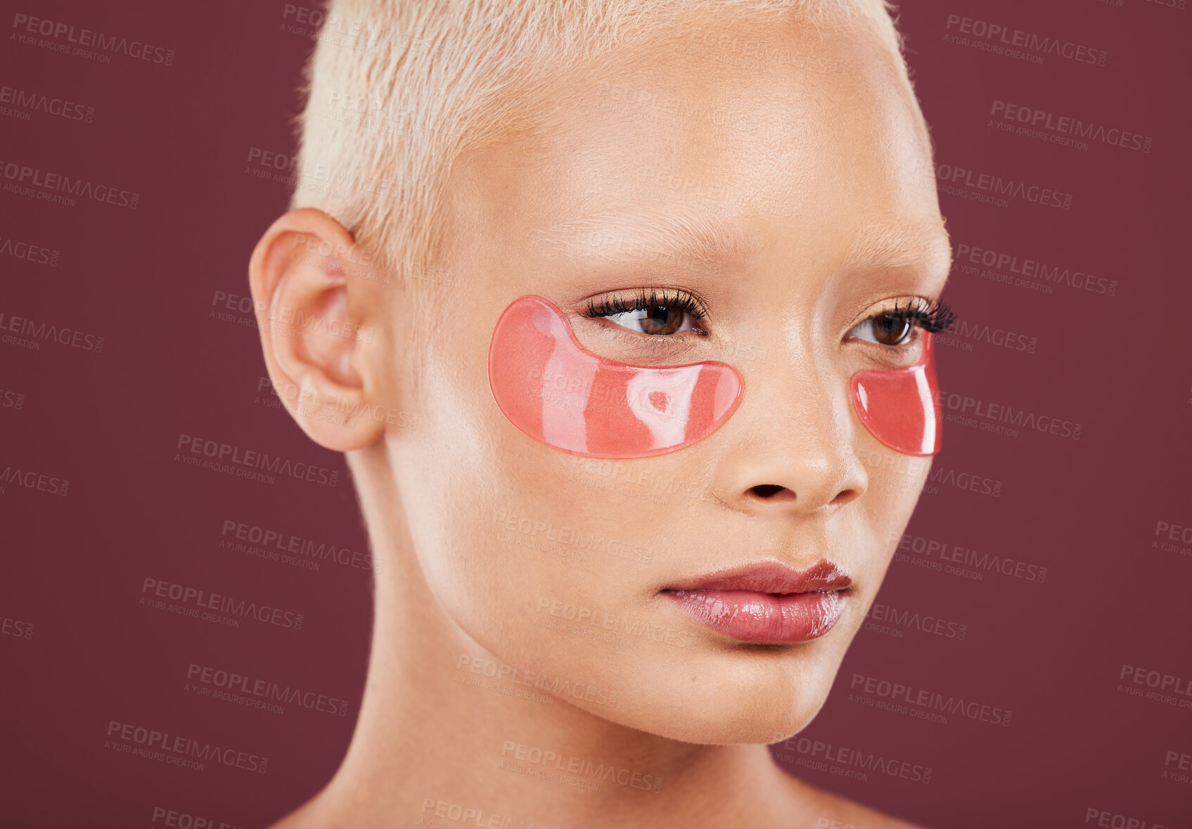 Buy stock photo Eye patches, skincare and cosmetics of black woman doing face cleaning and wellness facial. Beauty, skin glow and mockup of a young model in a studio for dermatology, collagen and self care treatment
