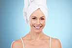 Hair towel, woman and portrait in studio, blue background and face beauty. Female model, head cloth and clean shower for skincare, dermatology and happy spa for wellness, smile and facial in bathroom