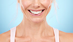 Smile, teeth whitening and woman mouth in studio, blue background and facial wellness. Closeup female model, clean dental and happy face of fresh breath, tooth implant and healthy aesthetic beauty 