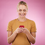 Woman, phone and pink background for communication, social media and online chat in studio. Happy model person with smartphone in hands for network connection or typing post on mobile app or website