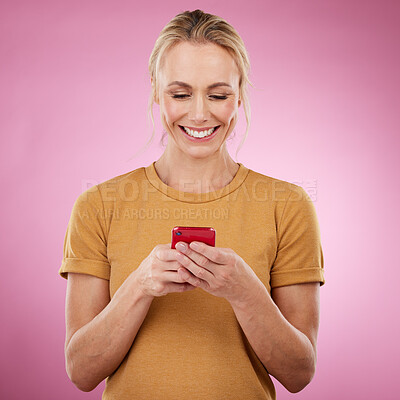 Buy stock photo Woman, phone and pink background for communication, social media and online chat in studio. Happy model person with smartphone in hands for network connection or typing post on mobile app or website