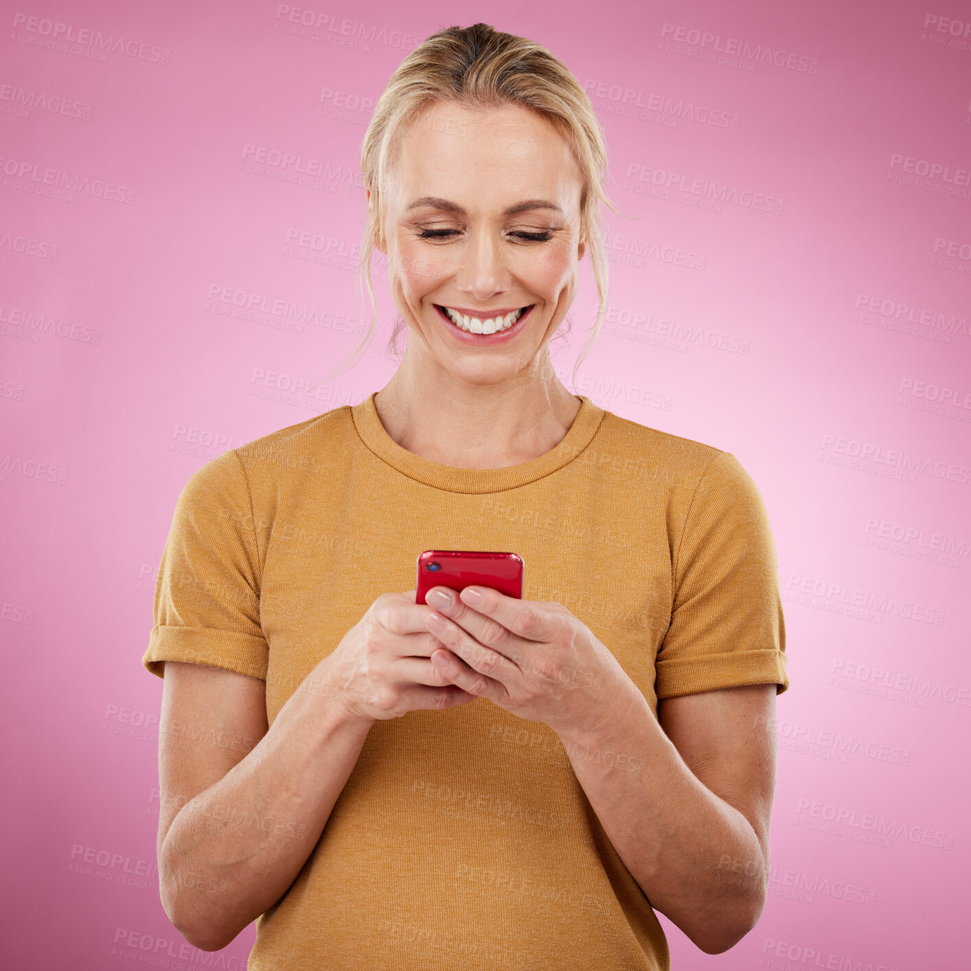 Buy stock photo Woman, phone and pink background for communication, social media and online chat in studio. Happy model person with smartphone in hands for network connection or typing post on mobile app or website