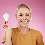 Lightbulb, portrait and woman isolated on pink background for beauty ideas, inspiration or cosmetics solution. Happy model or mature person with light bulb thinking of dermatology, skincare or health