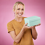 Gift, box and portrait of woman in studio with smile, pink background and package. Happy female model, present and surprise for birthday celebration, excited giveaway and promotion to celebrate deal