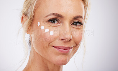 Buy stock photo Skincare, portrait and face cream for mature woman in studio for wellness, beauty and care on grey background. Facial, product or sunscreen by lady relax in luxury, cosmetic and lotion while isolated