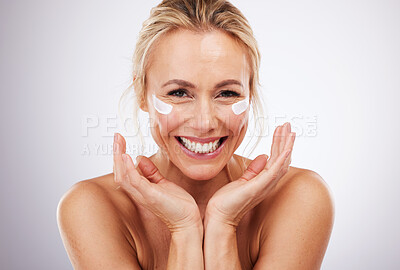 Buy stock photo Skincare, eye cream and portrait of mature woman, anti ageing treatment and isolated on grey studio background. Health, skin and model face with smile and collagen mask on eyes in luxury spa facial.