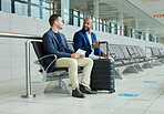 Ticket, airport and business partner or people talking of flight schedule, travel news or schedule update together. Conversation, waiting room and international or professional person with suitcase
