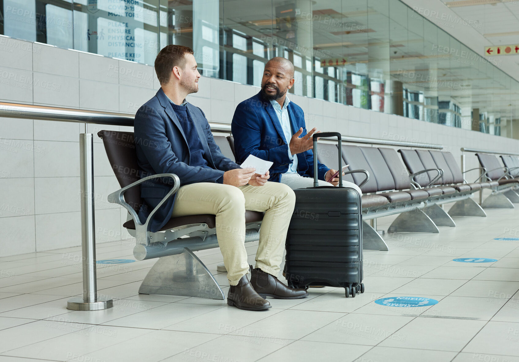 Buy stock photo Ticket, airport and business partner or people talking of flight schedule, travel news or schedule update together. Conversation, waiting room and international or professional person with suitcase
