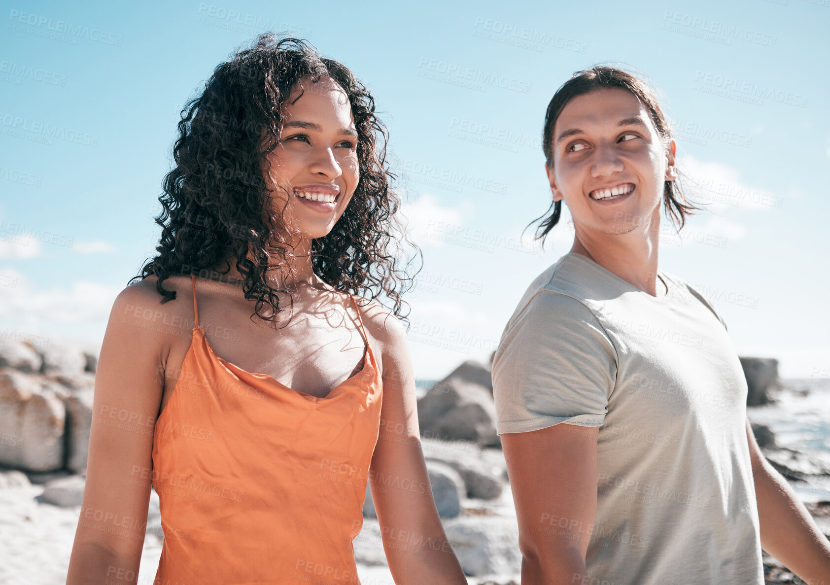 Buy stock photo Love, happy and couple at the beach for travel, fun and walking against blue sky background. Smile, affection and cheerful woman with man on vacation, relax and bond on summer trip together in Miami