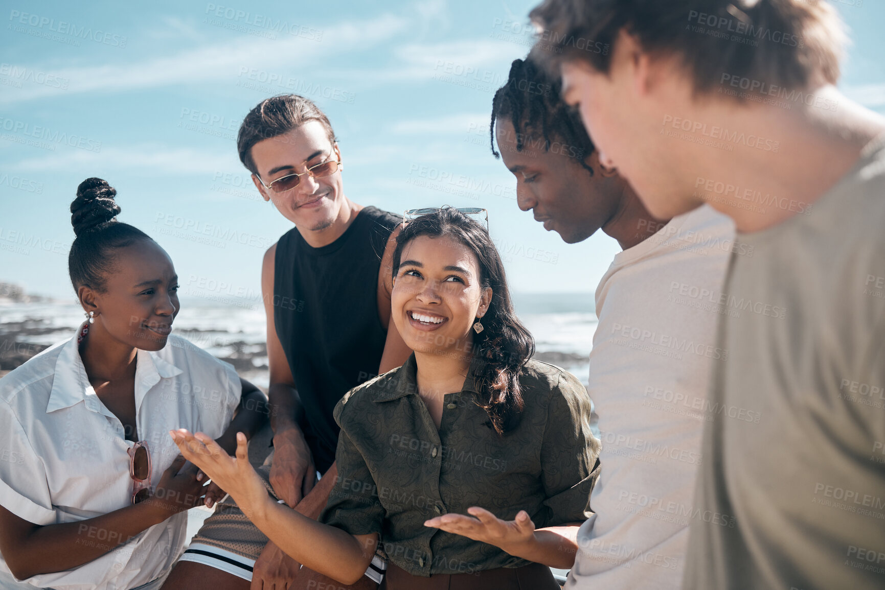 Buy stock photo Woman, talking and bonding friends by beach, ocean or sea in group social gathering, community trust or summer holiday vacation. Smile, happy and diversity people in travel location, relax or freedom