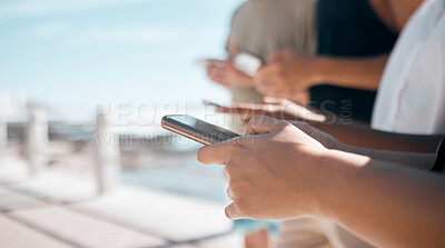 Buy stock photo People, hands and phone in networking at beach chatting, texting or social media together in the outdoors. Hand of group on smartphone for communication, typing or data sharing mobile app on mockup