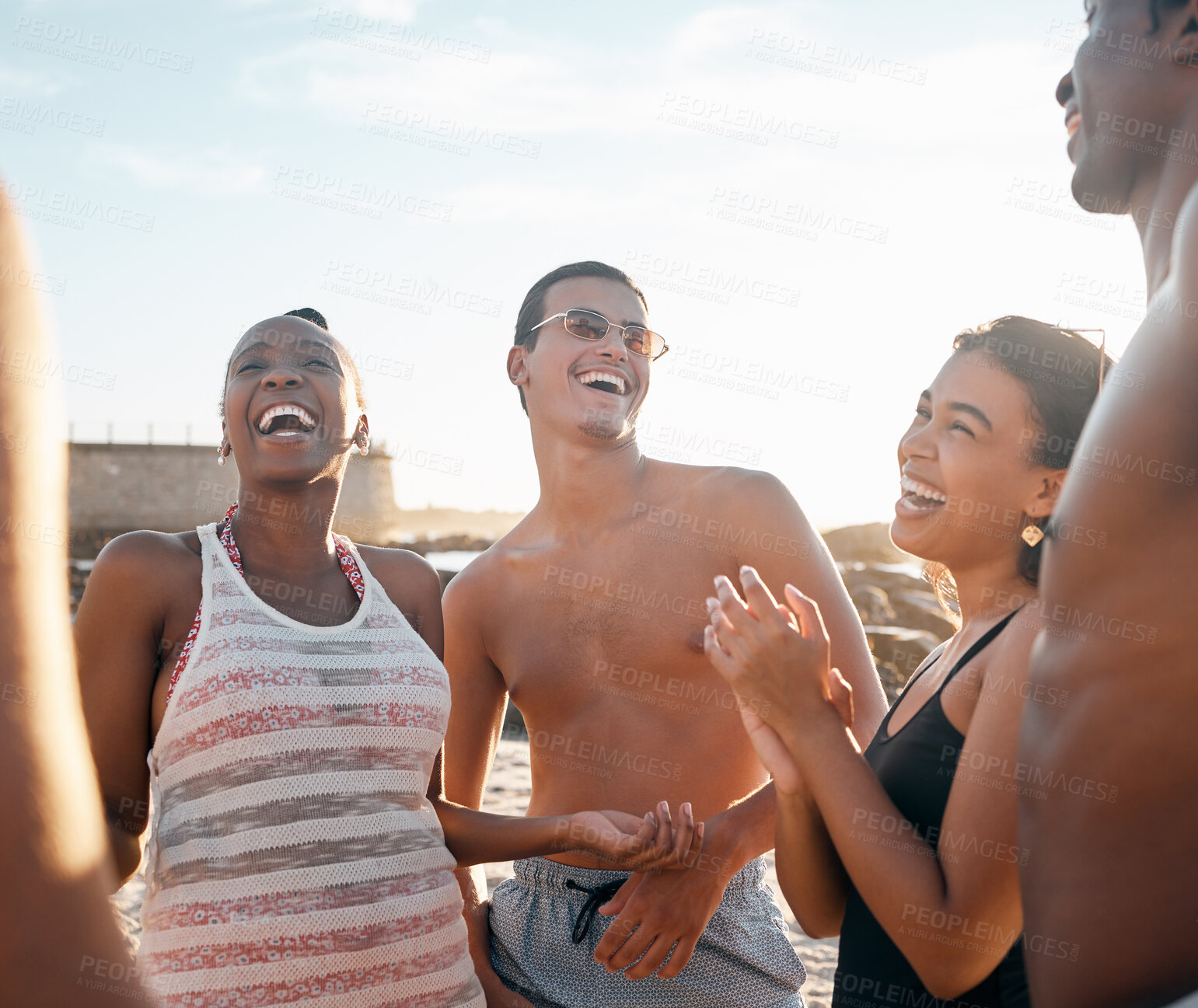 Buy stock photo Friends, laughing and bonding on sunset beach in social gathering joke, group vacation comedy or comic summer holiday. Smile, happy men and diversity women in travel party and funny sea storytelling