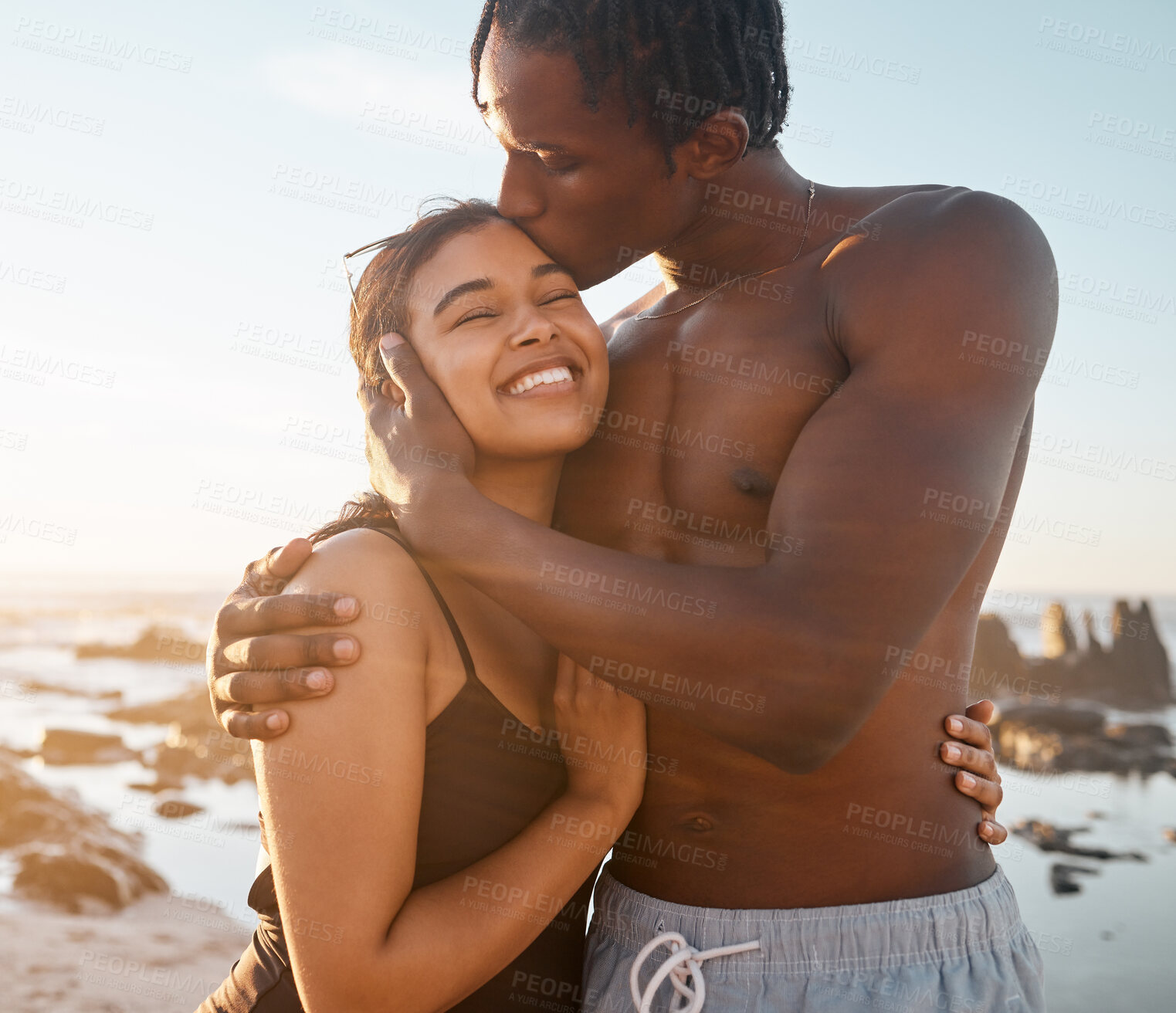 Buy stock photo Couple hug or forehead kiss on sunset beach in relax romance holiday, love vacation date or bonding summer. Smile, black woman or kissing man in swimwear embrace, trust or travel support by ocean sea