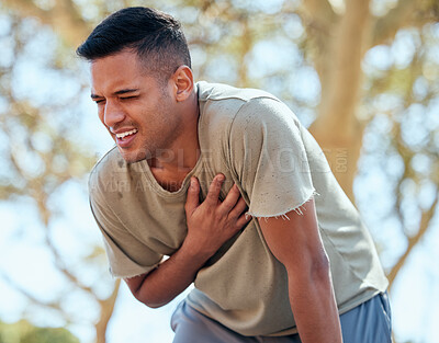 Buy stock photo Man, runner and heart attack pain in nature while running outdoors for health or wellness. Sports, cardiovascular emergency or male athlete with painful asthma, stroke or cardiac arrest after workout