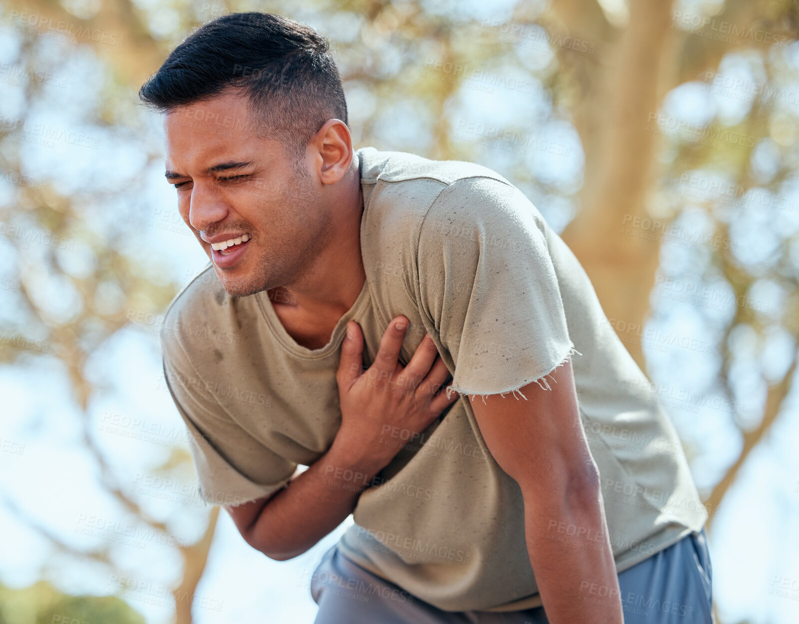 Buy stock photo Man, runner and heart attack pain in nature while running outdoors for health or wellness. Sports, cardiovascular emergency or male athlete with painful asthma, stroke or cardiac arrest after workout