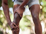 Hands, legs injury and knee pain at park after training, workout or exercise accident. Sports, fitness and black man or runner with fibromyalgia, inflammation or arthritis after 
jog and running.