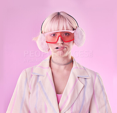 Buy stock photo Fashion, quirky and portrait of woman in studio for funny or comic face on pink background. Aesthetic model person with glasses and earmuffs for edgy vaporwave trend with creativity, humour and color