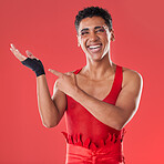 Hands, mockup and portrait of gen z man pointing in studio for makeup, fashion and punk aesthetic on red background. Hand, gesture and product placement with face of mexican male advertising space