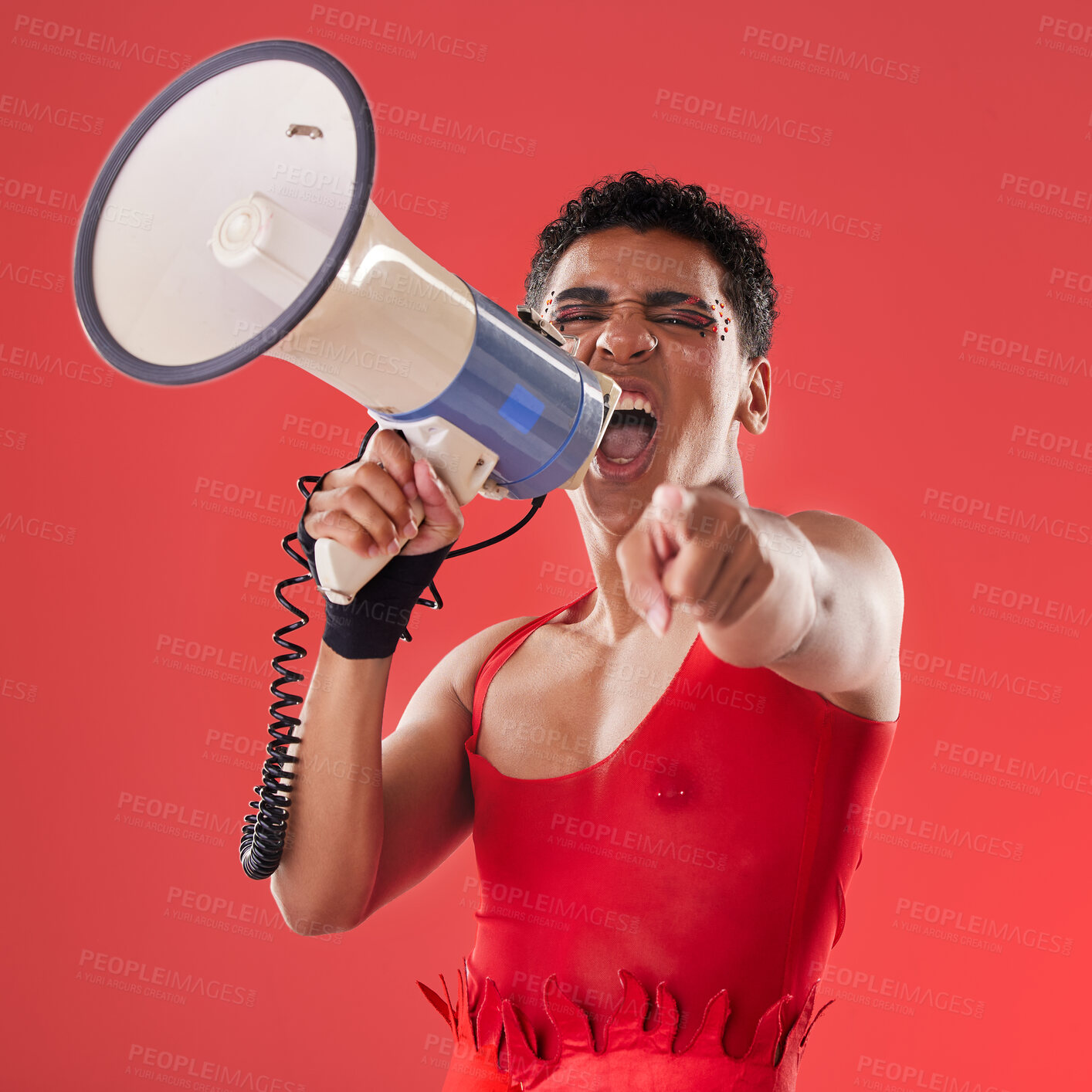 Buy stock photo Anger, gay and portrait of a man with a megaphone isolated on a red background in a studio. Decision, freedom and person shouting and talking into a speaker while pointing with choice on a backdrop