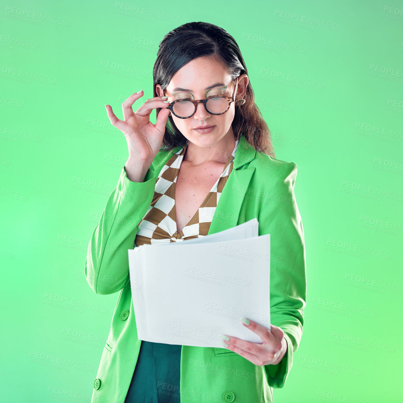 Buy stock photo Woman in glasses reading paper isolated on green background for fashion design career, gen z resume and internship. Young person or model with retro clothes and documents review for job opportunity