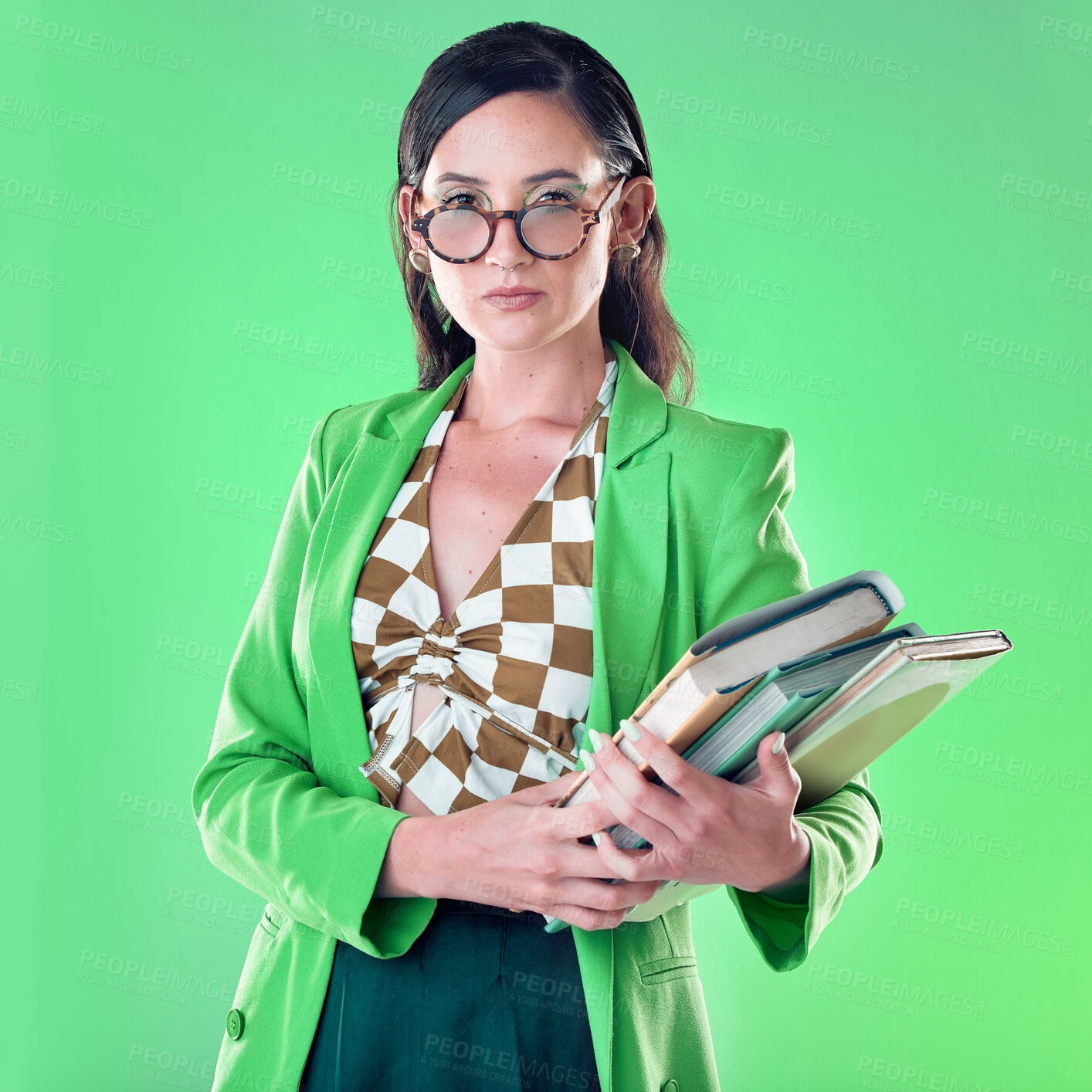 Buy stock photo Fashion, books and portrait of a woman in studio with glasses for teaching or education. Stylish, serious and female teacher with spectacles carrying textbooks for class isolated by green background.