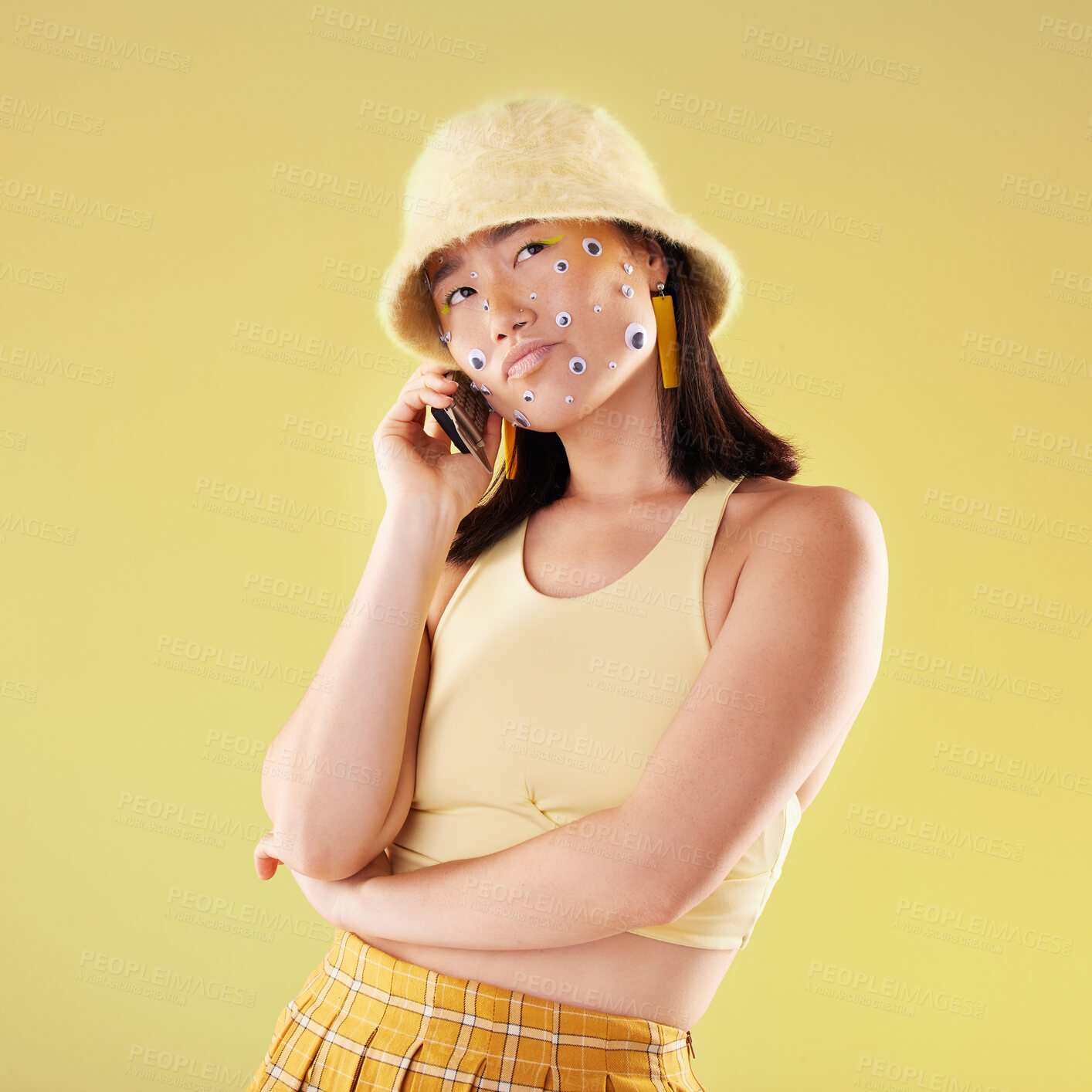 Buy stock photo Fashion, phone call and Asian woman in studio with style isolated on a yellow background. Trendy gen z girl model thinking about idea or question for communication, connection or mockup on cellphone