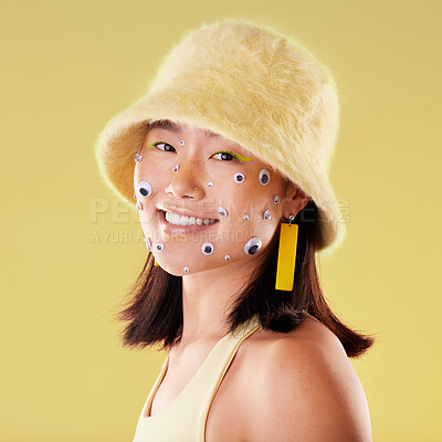 Buy stock photo Fashion, face and woman portrait with comic eyes isolated on yellow background in a studio. Happy, funny and stylish asian girl model with a smile, color and mindset for motivation and skin cosmetics