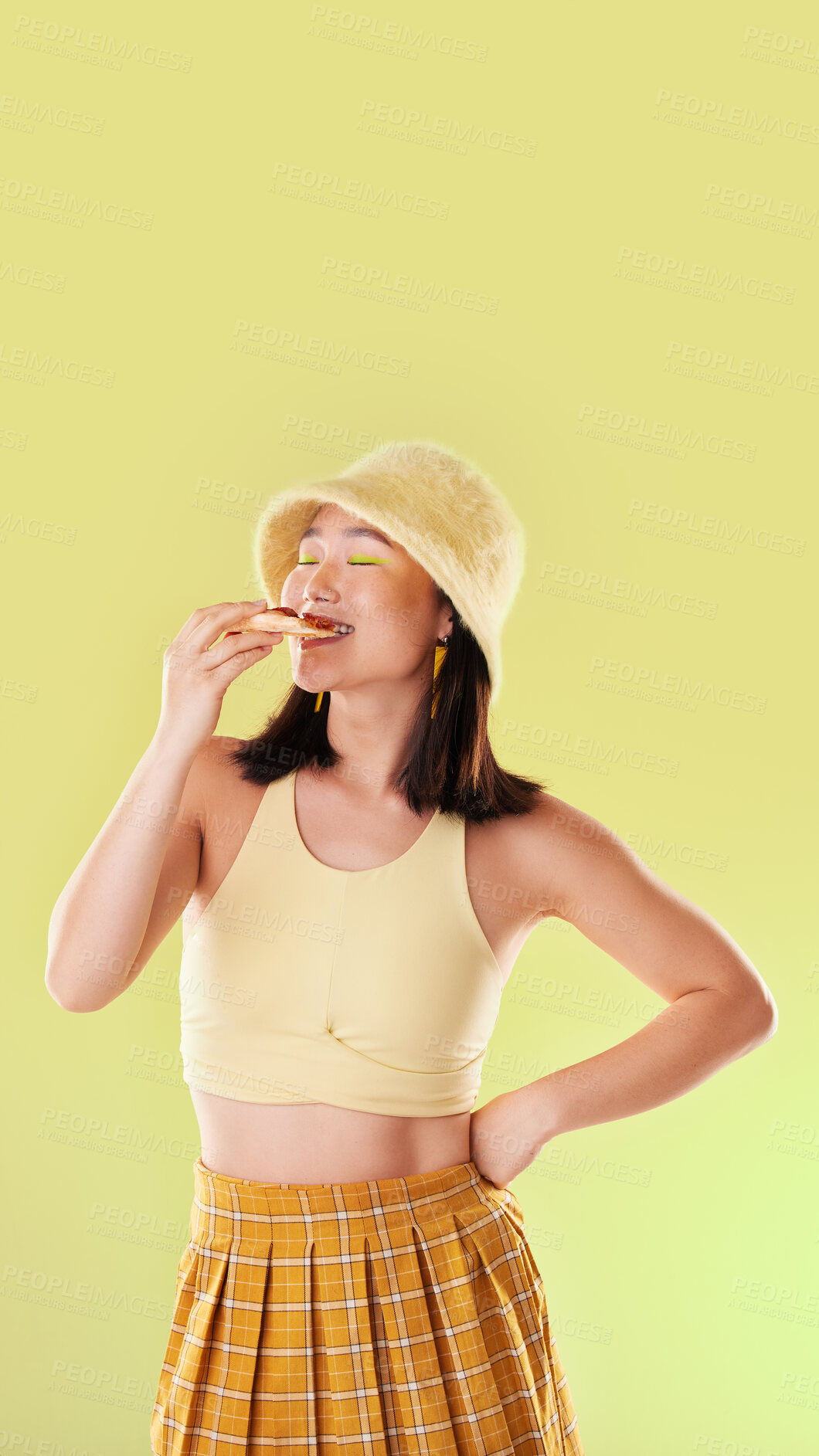 Buy stock photo Pizza, lunch and eating woman with food while isolated on a yellow background in a studio. Hungry, dinner and Asian girl enjoying a snack, take away or unhealthy meal with mockup on a backdrop