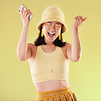 Phone, wow and celebration of woman in studio isolated on a yellow background. Excited winner, surprise and happy female with mobile smartphone celebrating after winning success, good news or lottery