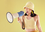 Asian, girl and studio with megaphone for protest, shout and speech for human rights by background. Young gen z model, loudspeaker broadcast and yellow 90s aesthetic for change, justice or opinion