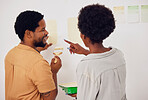 Painting, wall or happy black couple in DIY, home renovation or house remodel together with a paintbrush. Back view, smile or African man speaking to a woman working with team work in partnership 