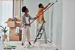 Painting, teamwork or black couple home renovation, diy or house remodel together with paintbrush or roller. Happy smile, woman and African man love working on wall with partnership or collaboration 