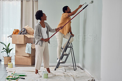 Buy stock photo Painting, teamwork or black couple home renovation, diy or house remodel together with paintbrush or roller. Happy smile, woman and African man love working on wall with partnership or collaboration 