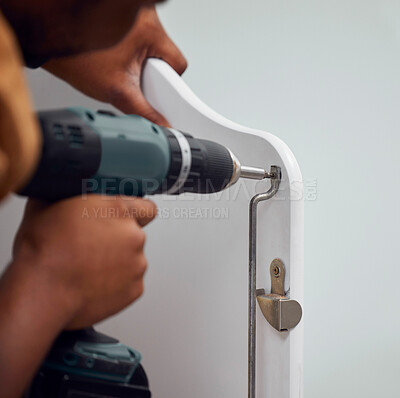 Buy stock photo Building, construction and hands of a person with a drill for a baby bed for preparation in a house. Metal, maintenance and man with a mechanical tool to build a frame for a child to sleep in a home