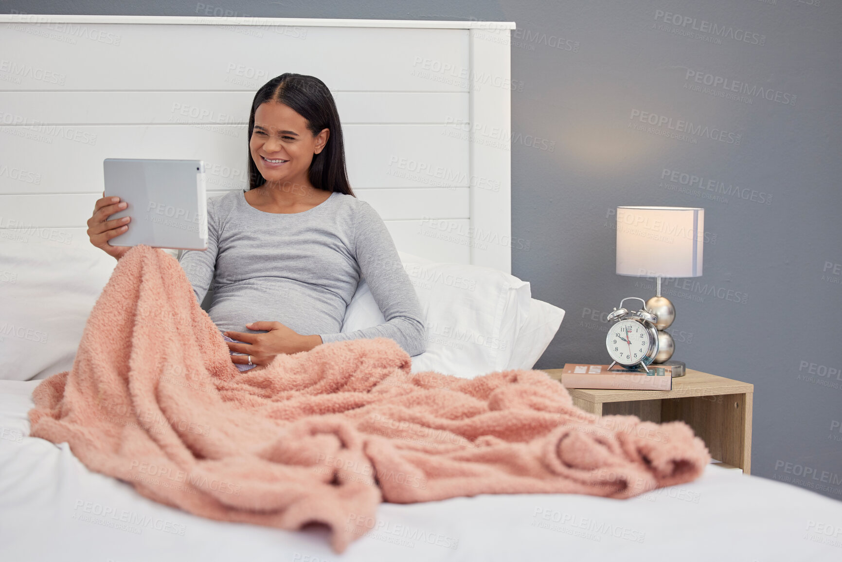 Buy stock photo Pregnant woman, video call and tablet for communication in home bedroom for online consultation. Person happy with internet connection for gynecology telehealth, pregnancy update and talking at night