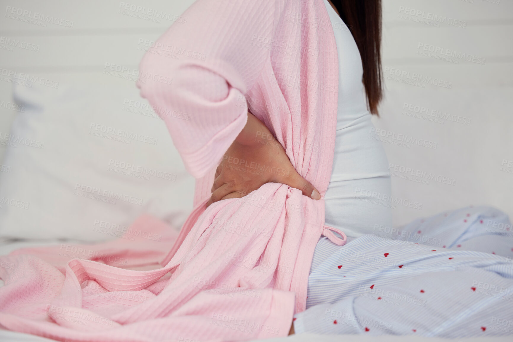 Buy stock photo Tired, healthcare and pregnant woman with back pain on a bed for rest, break and maternity leave. Sick, injury and girl with backache, fatigue and stress during pregnancy in a bedroom for motherhood