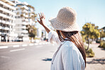 Woman, city and street to stop taxi, travel and transportation in summer, holiday and outdoor urban adventure. Girl, back and hand sign for transport in metro, road or cbd for vacation in sunshine