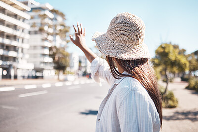 Buy stock photo Woman, city and street to stop taxi, travel and transportation in summer, holiday and outdoor urban adventure. Girl, back and hand sign for transport in metro, road or cbd for vacation in sunshine