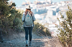 Woman hiking, travel and trekking in nature park, adventure and fitness outdoor with backpack and exercise. Female hiker on trail, back view and walking with healthy active lifestyle and fresh air